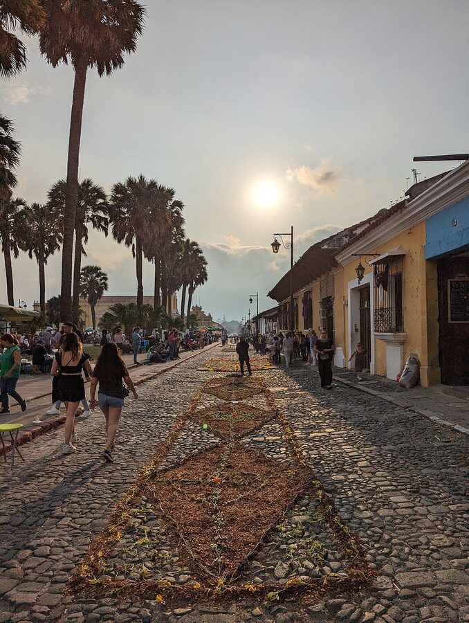 A sunlit alfombra of dyed sawdust on Antigua streets during Semana Santa