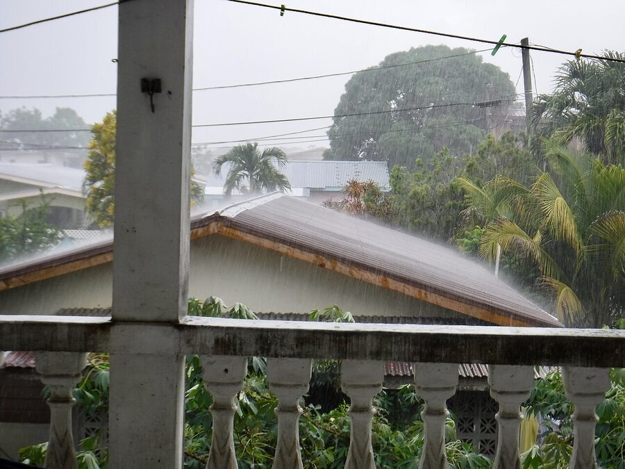 Heavy rainy season downpour over Belmopán rooftops