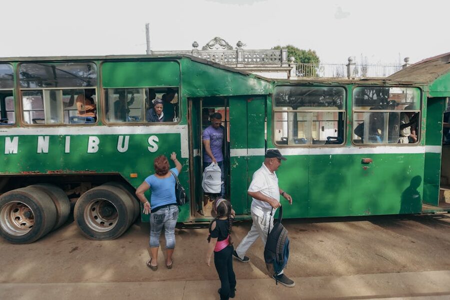 Travellers boarding a public bus in a Central American town
