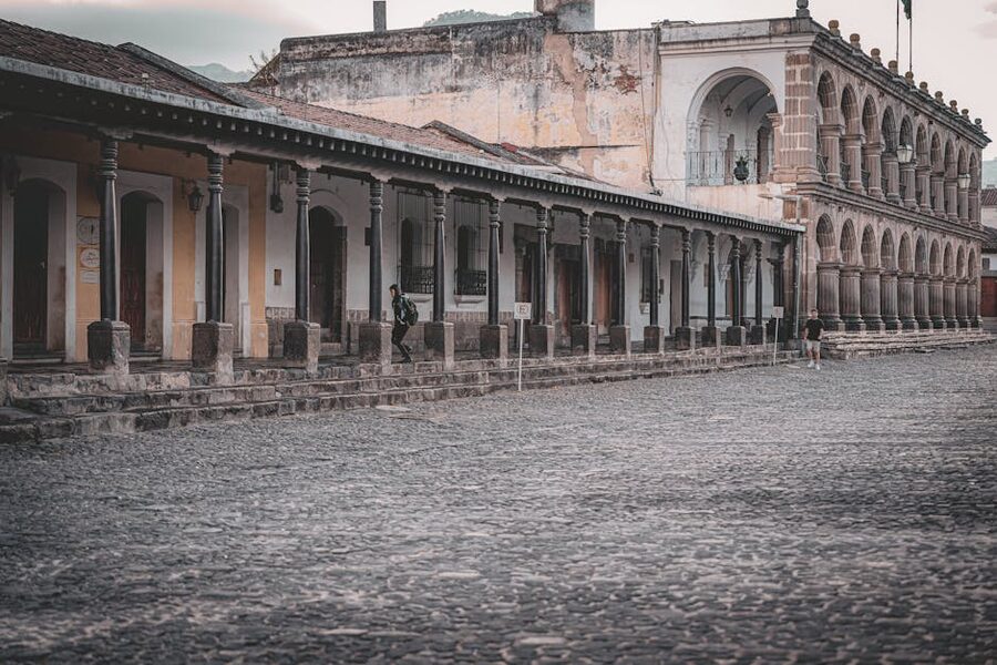 Cobblestone street with colonial archways in Antigua Guatemala