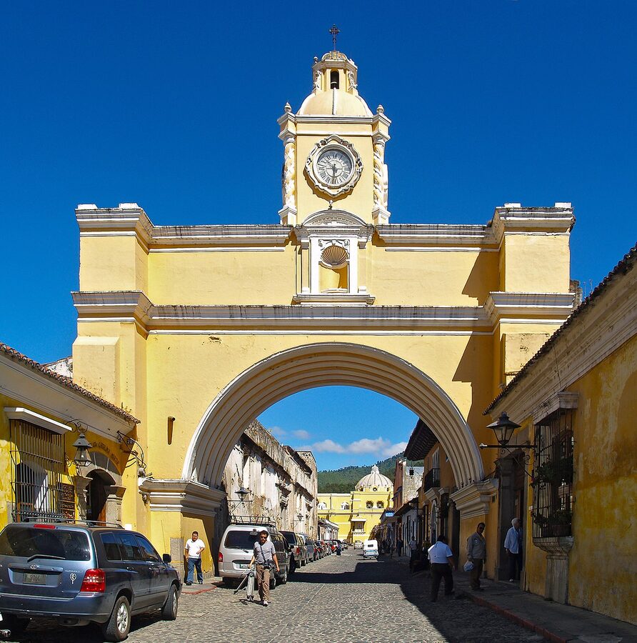 Arco de Santa Catalina yellow archway in Antigua Guatemala with Volcan Agua in background