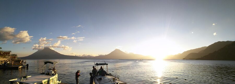 Wooden boats on Lake Atitlan shore at Panajachel Guatemala with volcano in background