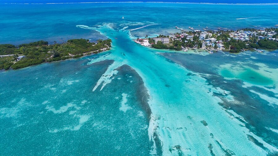 Aerial view of Caye Caulker island in turquoise water Belize