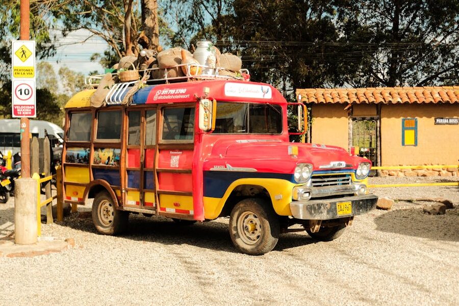 Colorful repurposed school bus camioneta painted in bright colors with goods on roof