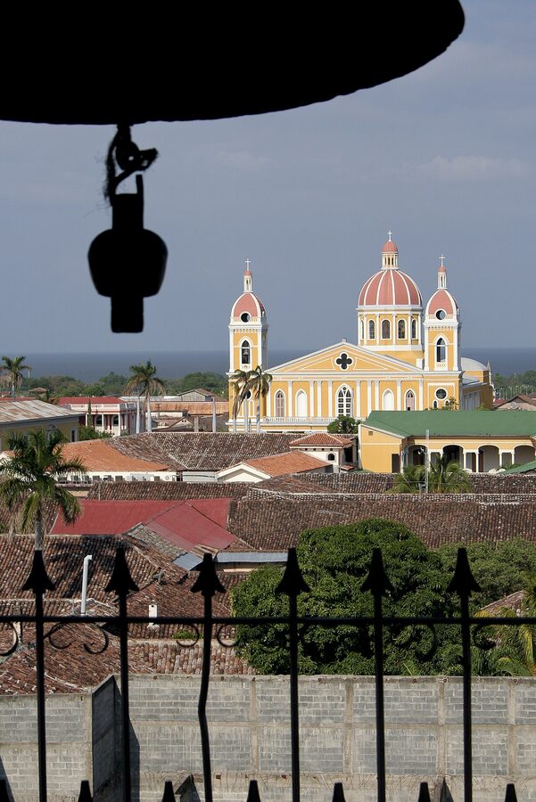 Yellow Cathedral of Granada Nicaragua with palm trees and colonial plaza