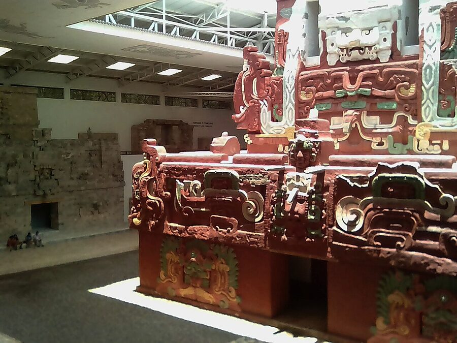 Rosalila Temple replica inside the Copán Sculpture Museum, painted red and ochre with carved monster masks on its facade