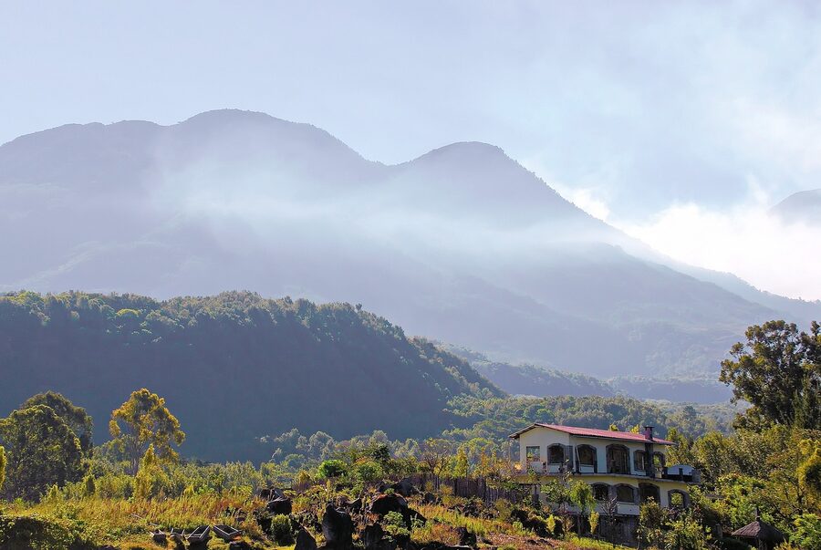 Lake Atitlan with volcanoes and clouds, view from San Antonio