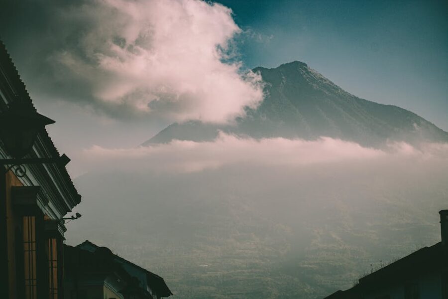View of a volcano with clouds over Guatemala City architecture