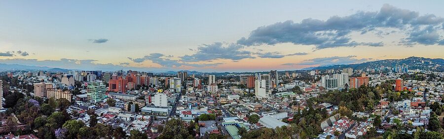 Modern high-rise skyline of Zona 10 in Guatemala City with mountains in the background