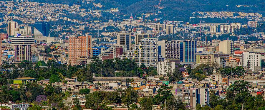 View of Zona 4 Guatemala City skyline with the capital's hills in the background