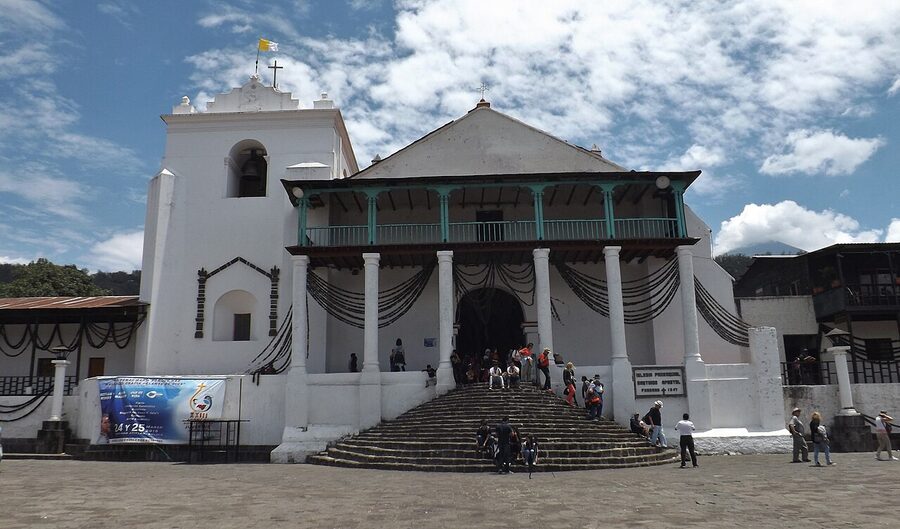 Parroquia Santiago Apostol church facade in Santiago Atitlan with local crowd on the steps