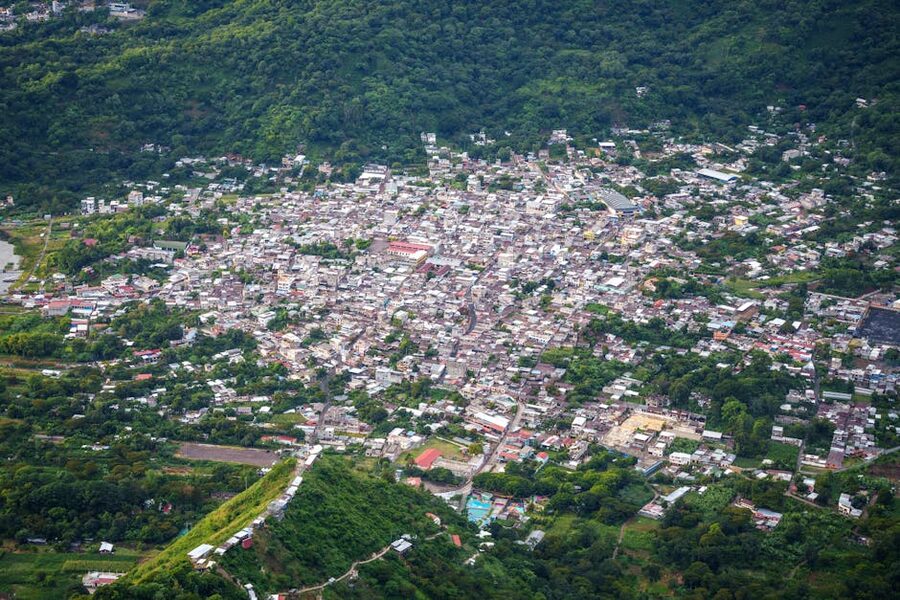 Aerial view of San Juan La Laguna showing colorful houses climbing the hillside above Lake Atitlan