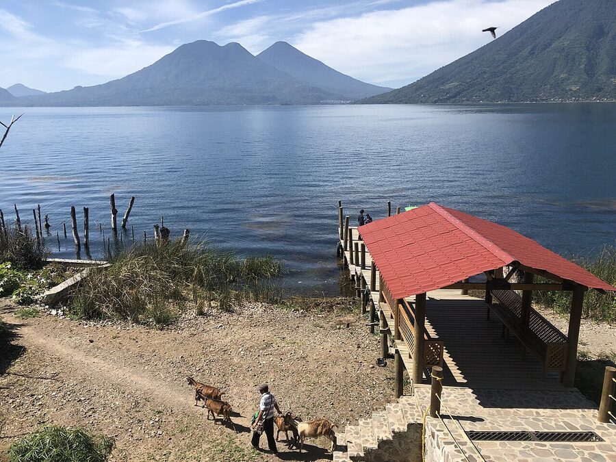 San Marcos La Laguna boat dock with passengers waiting and lake mountains in the background