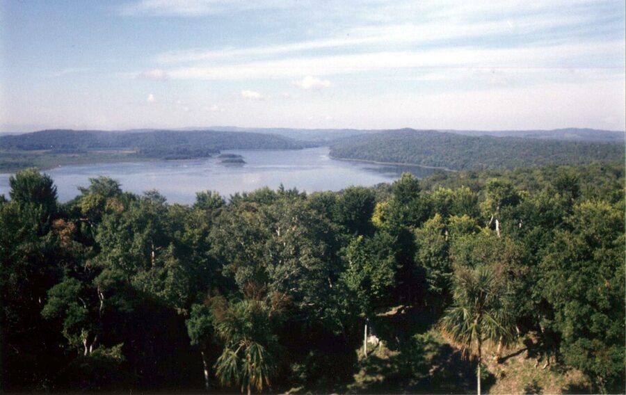 Laguna Yaxha at sunset behind the Maya ruins of Yaxha in Peten, Guatemala