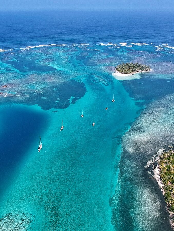 Sailboats anchored over coral reefs in the Guna Yala archipelago