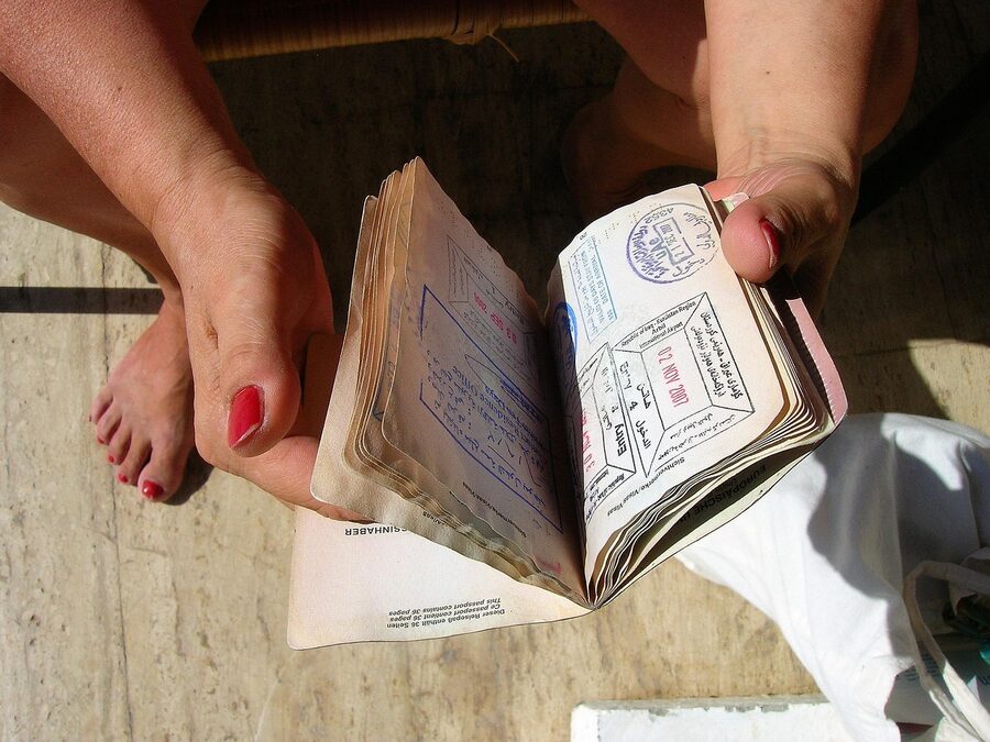 Passport with several rubber stamps and identity document on a flat surface