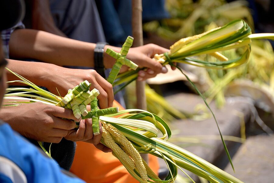 Hands weaving palm crosses for Palm Sunday in Tegucigalpa