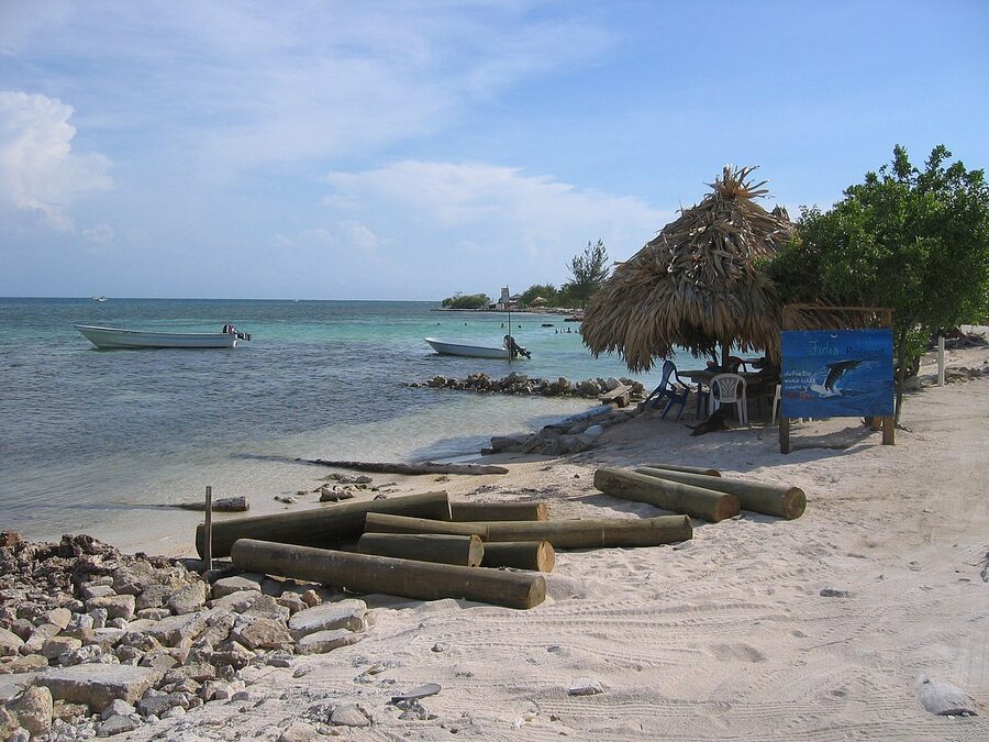 Beach palapa and small boats on Utila's coast, Honduras Bay Islands