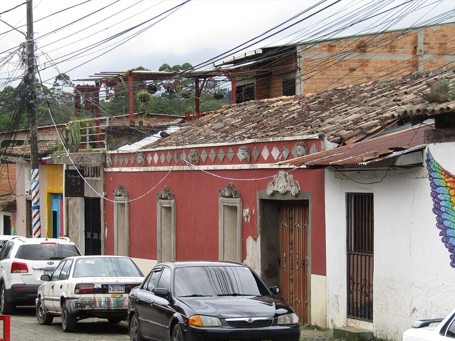 Colonial street in Valle de Angeles Honduras with cars and old houses