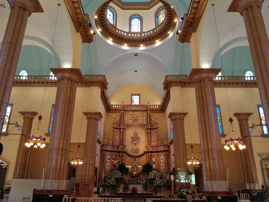 Interior of Basilica de Suyapa with stained glass windows and altar