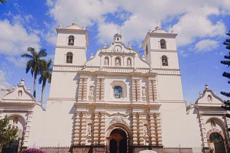 Catedral de San Miguel Arcangel facade in Tegucigalpa with framing palm trees