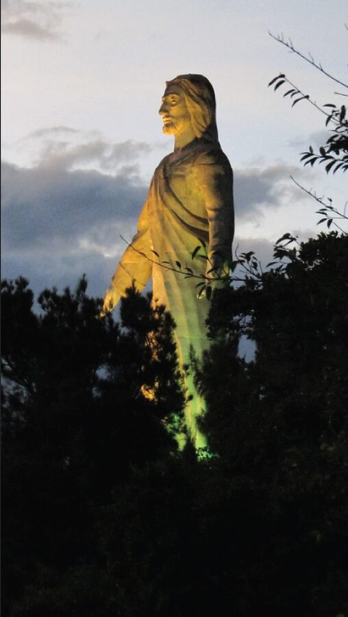 Illuminated Cristo del Picacho statue at dusk in Tegucigalpa