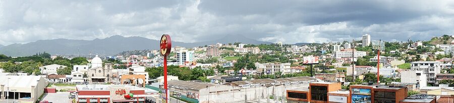 Panoramic view of Tegucigalpa with hills and storm clouds